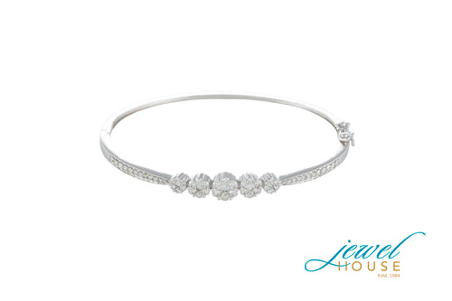 INVISIBLE-PAVE DIAMOND GRADUATED FLOWER BANGLE IN 14KT WHITE GOLD